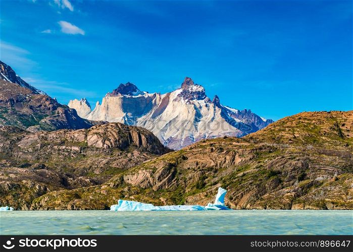 Beautiful landscape with Iceberg floating in the lake grey infront of the beautiful mountain at Torres del Paine National Park in Chile