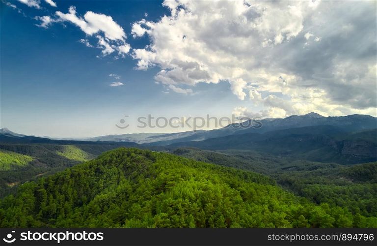 Beautiful landscape with trees and clouds in mountains. Mountain sky trees