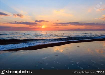 Beautiful landscape with tropical sea sunset on the beach. Picturesque sky reflection in water.