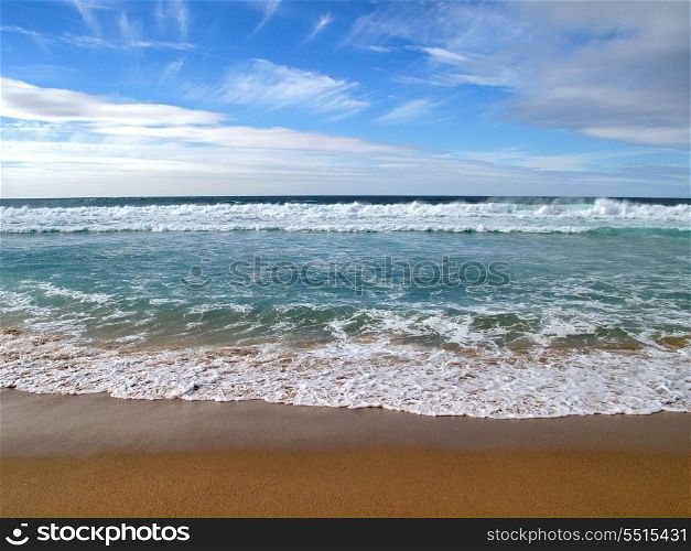 Beautiful landscape with waves breaking on shore of the sea