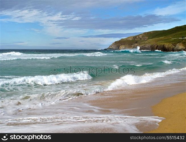 Beautiful landscape with waves breaking on shore of the sea