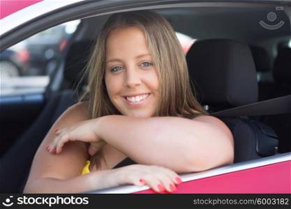 Beautiful large woman driving a red sports car