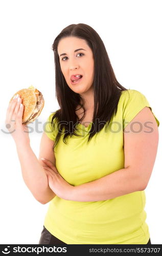 Beautiful large woman, trying to resist to an appetizing hamburger, which would kill her diet