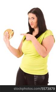 Beautiful large woman, trying to resist to an appetizing hamburger, which would kill her diet