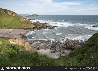 Beautiful late evening Spring landscape image of Ayrmer Cove on Devon coastline in England