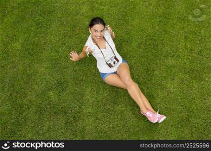 Beautiful latin american teenager lying on the grass