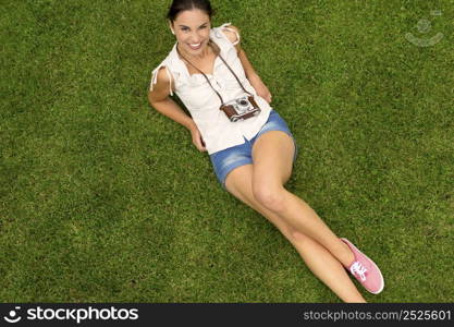 Beautiful latin american teenager lying on the grass