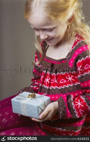 beautiful laughing girl holding presents in hands