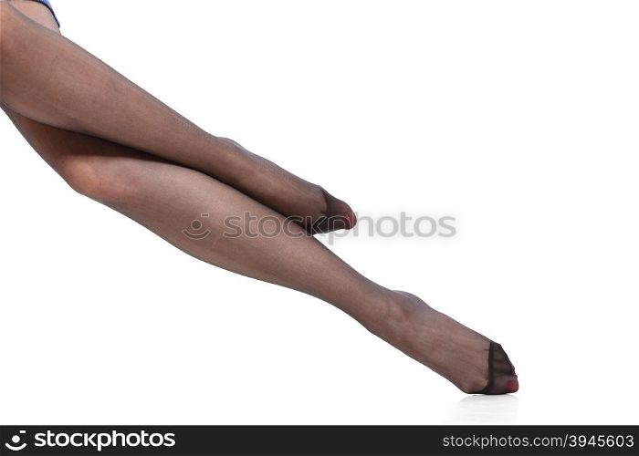 Beautiful legs of slim girl. Beauty woman legs in black tights. Part body of slim attractive girl wearing pantyhose isolated on white.