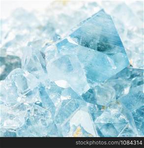 Beautiful light blue crystals of the collectible mineral celestite close-up. Celestine is the main ore of strontium