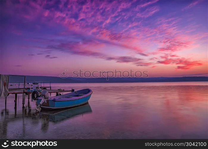 Beautiful light composition and mood of the boat at a pier after sunset. Beautiful light composition and mood of the boat at a pier after