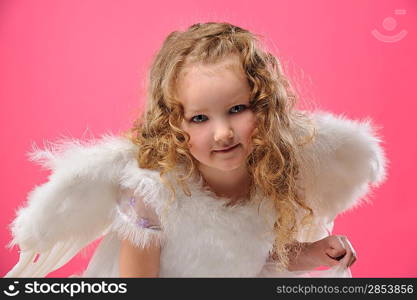 Beautiful little angel girl isolated on pink background