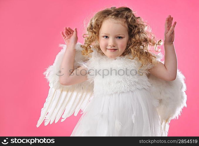 Beautiful little angel girl isolated on pink background