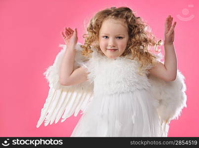 Beautiful little angel girl isolated on pink background