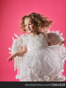 Beautiful little angel girl isolated on pink background