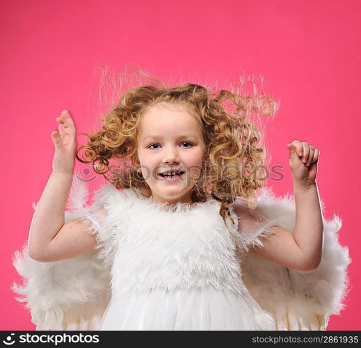 Beautiful little angel girl isolated on pink background