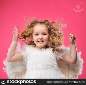 Beautiful little angel girl isolated on pink background