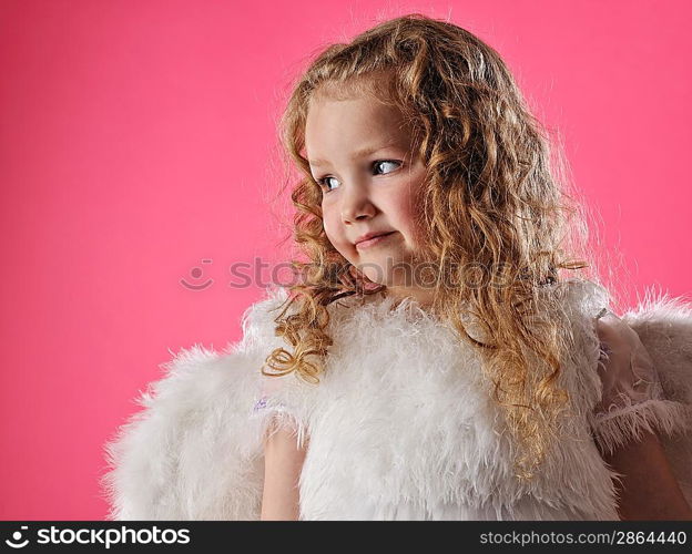 Beautiful little angel girl isolated on pink background