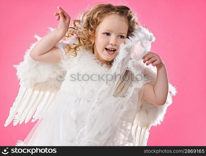 Beautiful little angel girl isolated on pink background