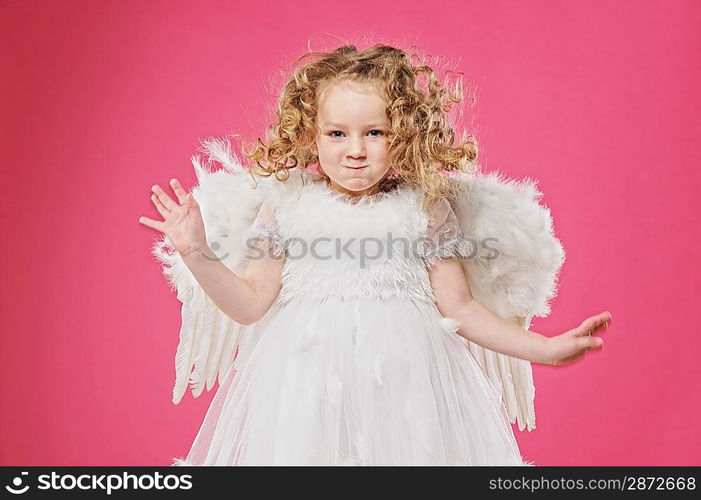 Beautiful little angel girl isolated on pink background