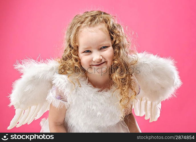 Beautiful little angel girl isolated on pink background