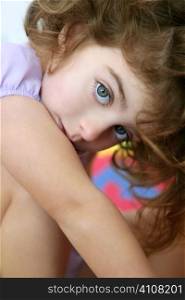 Beautiful little blue eyes preschooler girl hide looking at camera