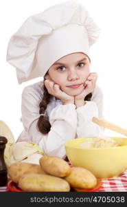 Beautiful little chief cooker on the desk with vegetables, isolated on white background