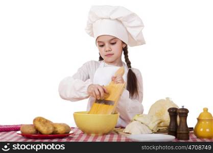 Beautiful little chief cooker on the desk with vegetables, isolated on white background