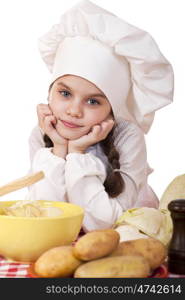 Beautiful little chief cooker on the desk with vegetables, isolated on white background