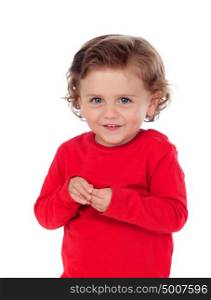 Beautiful little child two years old with red jersey smiling isolated on a white background