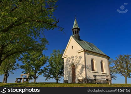 Beautiful little church with trees and blue sky. Brno-Lisen - Czech Republic. Chapel of Our Lady Help of Christians