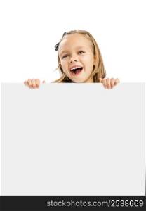 Beautiful little girl holding and showing something on a whiteboard