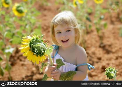 Beautiful little girl in a summer sunflower colorful field
