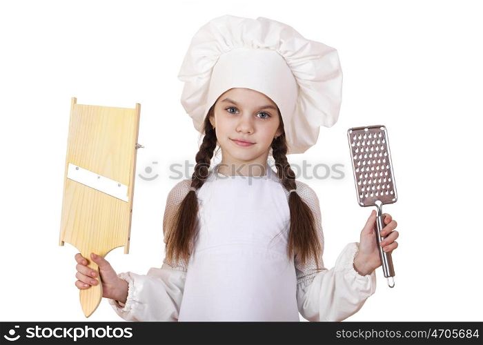 Beautiful little girl in a white apron and holding a wooden grater shredder vegetables, isolated on white background