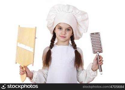 Beautiful little girl in a white apron and holding a wooden grater shredder vegetables, isolated on white background