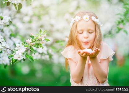 Beautiful little girl in blooming apple tree garden. Adorable little girl in blooming apple garden on beautiful spring day