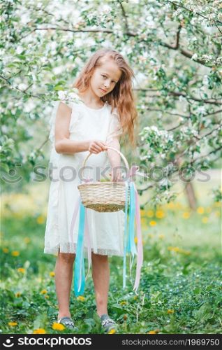 Beautiful little girl in blooming apple tree garden on spring day. Adorable little girl in blooming apple garden on beautiful spring day