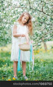 Beautiful little girl in blooming apple tree garden on spring day. Adorable little girl in blooming apple garden on beautiful spring day