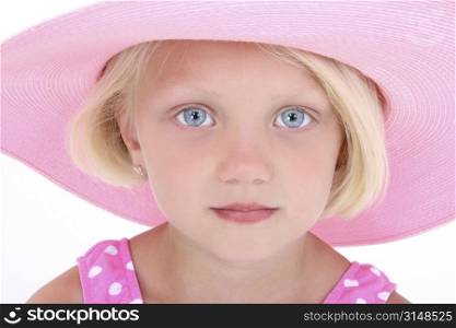 Beautiful Little Girl In Pink Swim Suit And Large Hat. Close-up with serious expression. Shot in studio over white with the Canon 20D.
