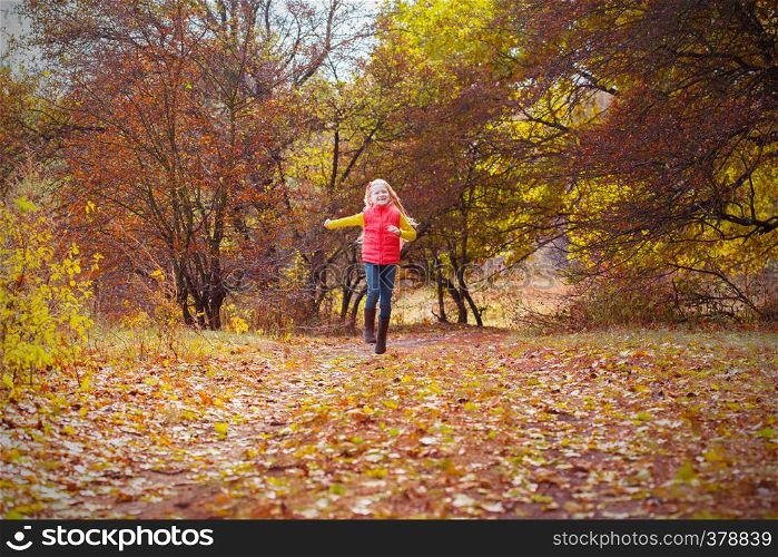 beautiful little girl in the autumn forest