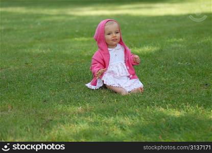 beautiful little girl on green grass
