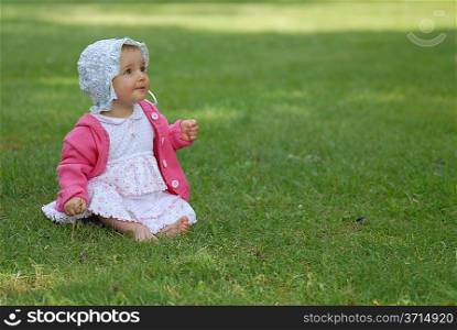beautiful little girl on green grass