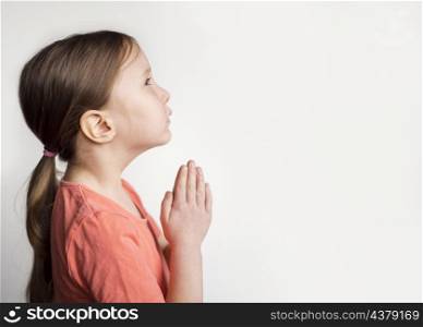 beautiful little girl praying with copy space