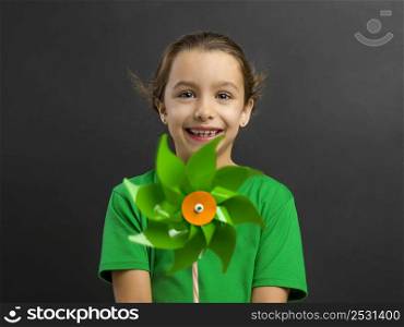 Beautiful little girl smilling and holding a windmill