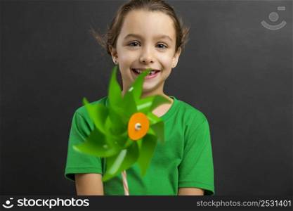 Beautiful little girl smilling and holding a windmill
