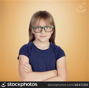 Beautiful little girl with glasses on a over orange background