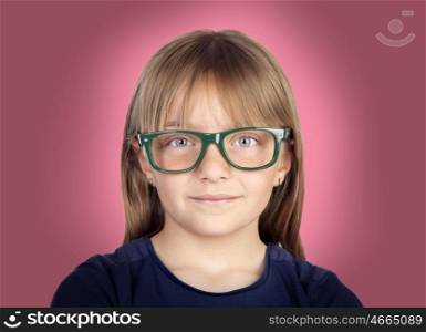 Beautiful little girl with glasses on a over pink background