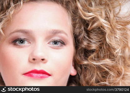 beautiful long blond curly hair of young attractive woman to lie