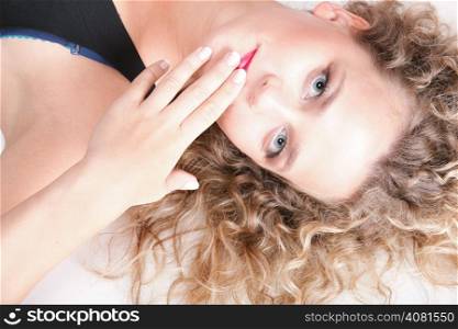beautiful long blond curly hair of young attractive woman to lie