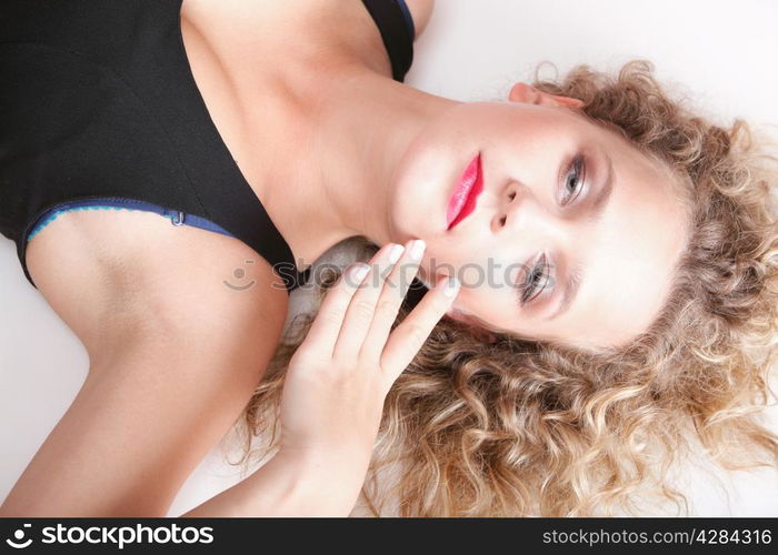 beautiful long blond curly hair of young attractive woman to lie